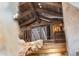 Open loft area with a wrought iron railing, wooden beams, and rustic charm at 3755 N Rampart Range Rd, Littleton, CO 80125