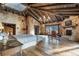 Bright main bedroom boasts hardwood floors, warm lighting, stone accent wall and fireplace at 3755 N Rampart Range Rd, Littleton, CO 80125