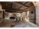 Spacious outdoor dining area with stone arches and wood beam ceiling, perfect for entertaining at 3755 N Rampart Range Rd, Littleton, CO 80125