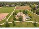 Aerial view of neighborhood park with baseball field, playground, picnic shelter, pathways, and open green space at 11570 Depew Ct, Westminster, CO 80020