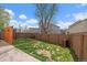 Backyard with grass, privacy fence, storage boxes and mature trees providing shade at 11570 Depew Ct, Westminster, CO 80020