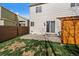 Backyard patio with sliding glass door leads to backyard with privacy fence and low-maintenance landscaping at 11570 Depew Ct, Westminster, CO 80020