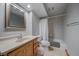 This bathroom features tile flooring, granite countertops, framed mirror and a shower with a shower curtain at 11570 Depew Ct, Westminster, CO 80020