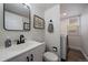 Modern bathroom featuring a sleek vanity, contemporary fixtures, and a convenient laundry area at 11570 Depew Ct, Westminster, CO 80020