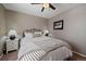 Neutral bedroom with a comfortable bed, soft lighting, and a ceiling fan, creating a relaxing atmosphere at 11570 Depew Ct, Westminster, CO 80020