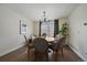 Cozy dining area with a round table, elegant chandelier, and a large window providing plenty of natural light at 11570 Depew Ct, Westminster, CO 80020