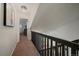 Hallway with natural light, features a railing overlooking the main floor and leads to a bedroom at 11570 Depew Ct, Westminster, CO 80020