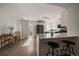 Bright kitchen with modern appliances, white cabinets, a breakfast bar, and a view of the dining area and backyard at 11570 Depew Ct, Westminster, CO 80020