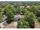 An aerial view of a beautiful home surrounded by lush greenery and mature trees at 7862 W 84Th Ct, Arvada, CO 80005