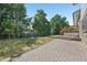 The property features a brick patio and stairs leading to a wooden deck, perfect for outdoor gatherings at 7862 W 84Th Ct, Arvada, CO 80005