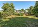 A serene backyard with mature trees and lush greenery surrounds the property at 7862 W 84Th Ct, Arvada, CO 80005