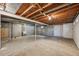 Unfinished basement offers potential for customization, features open ceilings and walls, and concrete flooring at 7862 W 84Th Ct, Arvada, CO 80005