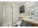 Bathroom with gray vanity, shower, and tile flooring at 7862 W 84Th Ct, Arvada, CO 80005
