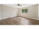 Bedroom featuring wood-look floors, a ceiling fan, and natural light from the window at 7862 W 84Th Ct, Arvada, CO 80005