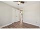 Bedroom features wood-look floors, a ceiling fan, and closet with white bi-fold doors at 7862 W 84Th Ct, Arvada, CO 80005