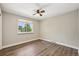 Comfortable bedroom with wood-look floors, a ceiling fan, and natural light from the window at 7862 W 84Th Ct, Arvada, CO 80005