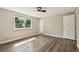 Bright bedroom with wood-look floors, a ceiling fan, and a window with natural light at 7862 W 84Th Ct, Arvada, CO 80005