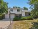 Charming two-story home with a brick facade, an attached two-car garage, and a well-maintained front yard at 7862 W 84Th Ct, Arvada, CO 80005