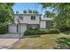 Charming two-story home with a brick facade, an attached two-car garage, and a well-maintained front yard at 7862 W 84Th Ct, Arvada, CO 80005