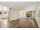 Inviting living room featuring a cozy brick fireplace and hardwood floors at 7862 W 84Th Ct, Arvada, CO 80005