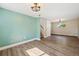 Living room showcasing hardwood flooring, fresh paint, and a staircase leading to the upper floor at 7862 W 84Th Ct, Arvada, CO 80005