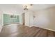 Large open living room featuring luxury laminate flooring, neutral paint, and natural lighting at 7862 W 84Th Ct, Arvada, CO 80005