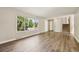 Open living room with a large window and hardwood floors at 7862 W 84Th Ct, Arvada, CO 80005