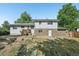 Charming home featuring a two-story layout, a brick facade, and a wooden deck entrance at 7862 W 84Th Ct, Arvada, CO 80005