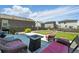 Back patio with outdoor seating around a fire table and grill, perfect for entertaining at 27125 E Bayaud Ave, Aurora, CO 80018