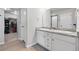 Bathroom featuring double vanity with granite countertops and walk-in closet at 27125 E Bayaud Ave, Aurora, CO 80018