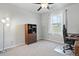 Bedroom with a ceiling fan, hutch, desk, and a bright window at 27125 E Bayaud Ave, Aurora, CO 80018