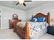 Comfortable bedroom with wood furniture, ceiling fan, and well-lit interiors at 27125 E Bayaud Ave, Aurora, CO 80018
