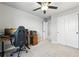 Bedroom with a ceiling fan, closet, and desk at 27125 E Bayaud Ave, Aurora, CO 80018