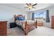 Cozy bedroom with a ceiling fan, large window, and warm, inviting decor at 27125 E Bayaud Ave, Aurora, CO 80018