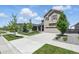Suburban home on a tree-lined street featuring a well-kept lawn and an attached garage at 27125 E Bayaud Ave, Aurora, CO 80018