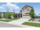 Inviting two-story home with a well-manicured lawn, shade trees, and a two-car garage at 27125 E Bayaud Ave, Aurora, CO 80018