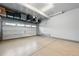 Well-lit garage with ample ceiling storage racks and an insulated garage door at 27125 E Bayaud Ave, Aurora, CO 80018