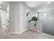 Upstairs hallway with neutral walls and carpet, with decorative plants at window ledge at 27125 E Bayaud Ave, Aurora, CO 80018