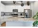 Spacious kitchen island with granite counters, microwave, and stainless steel refrigerator at 27125 E Bayaud Ave, Aurora, CO 80018