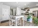 Updated kitchen featuring white cabinets, stainless steel appliances and a breakfast bar at 27125 E Bayaud Ave, Aurora, CO 80018