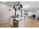 Bright, airy kitchen with granite countertops and stainless steel dishwasher, with island overlooking living area at 27125 E Bayaud Ave, Aurora, CO 80018