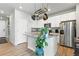 Bright kitchen with granite countertops, stainless steel appliances and hanging pot rack at 27125 E Bayaud Ave, Aurora, CO 80018
