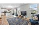Open-concept living space with a view of the kitchen, wood floors, and natural light at 27125 E Bayaud Ave, Aurora, CO 80018