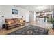 Inviting living room flowing into the kitchen, featuring wood floors and neutral decor at 27125 E Bayaud Ave, Aurora, CO 80018