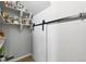 Walk-in pantry with sliding barn door and open shelving for optimal storage at 27125 E Bayaud Ave, Aurora, CO 80018
