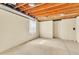Unfinished basement featuring an open ceiling and concrete floor at 7707 S Curtice Way # D, Littleton, CO 80120