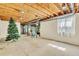Partially finished basement provides ample room with exposed wood and some storage solutions at 7707 S Curtice Way # D, Littleton, CO 80120