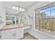 Comforting main bathroom including a view of the sink/vanity and a large window with a view of outside at 7707 S Curtice Way # D, Littleton, CO 80120