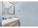 Powder room featuring a modern wood vanity, vessel sink, and a stylish framed mirror against light blue walls at 7707 S Curtice Way # D, Littleton, CO 80120