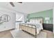 Bright bedroom features a cozy bed, ceiling fan, white walls, and a windowed alcove perfect for relaxing at 7707 S Curtice Way # D, Littleton, CO 80120